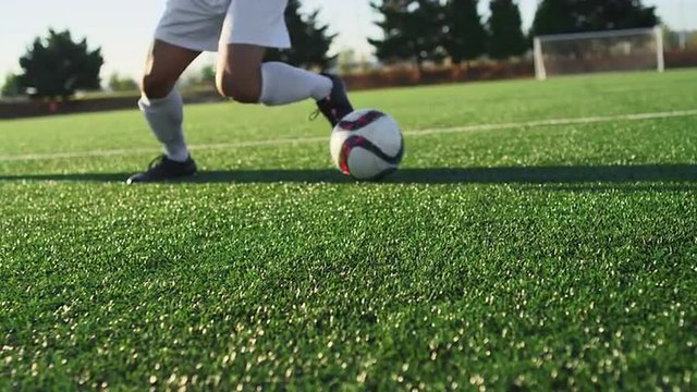 A soccer player does some fancy footwork and opponents slide tackle him
