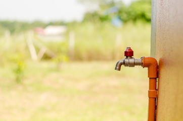 Outside faucet with orange pipe