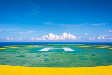 Empty oil rig helipad with few cloud and blue sky