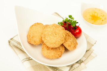 Fried coated cutlets with cherry tomatoes in a bowl