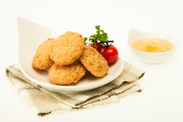 Fried coated cutlets with cherry tomatoes in a bowl