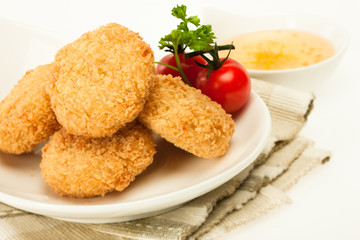 Fried coated cutlets with cherry tomatoes in a bowl