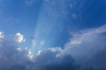 Fototapeta na wymiar sun beam in blue sky with clouds background