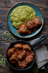 Meatballs with green peas, view from above, studio shot