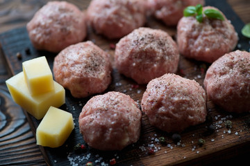 Close-up of uncooked meatballs with parmesan, selective focus