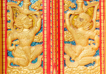 The hanuman golden carved on red door in buddhism temple