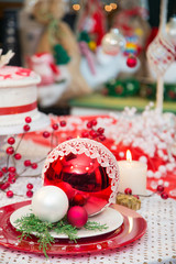 Christmas ornaments on decorated holiday table.