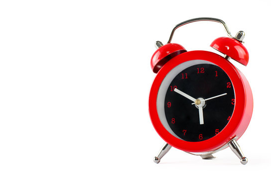 Little red alarm clock isolated on white with copy space for tex