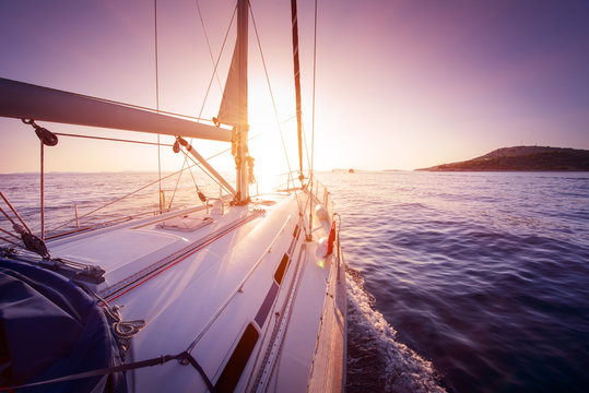 Fototapeta amazing view to yacht sailing at sunset