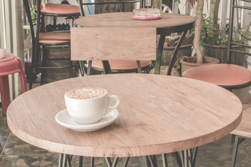 Coffee latte on the wooden table - Vintage Filter Effect