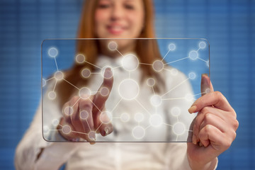 Smiling woman pressing touch screen on social network icon