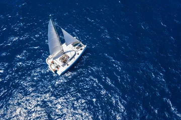 Zelfklevend Fotobehang Amazing view to Catamaran cruising in open sea at windy day. Drone view - birds eye angle © dell