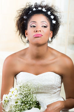Portrait of beautiful exotic emotional bride looking bored