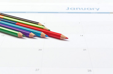 Business concept with color pencils on calendar background - sel
