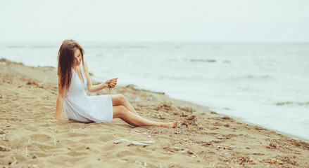 Fototapeta na wymiar Beautiful girl resting on beach