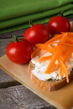 Slice of bread with fresh cheese and carrot shavings