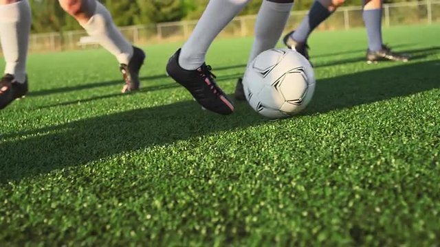 A soccer player does some fancy footwork and opponents slide tackle him
