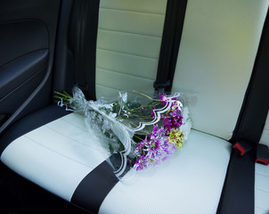 dahlias bouquet on car rearr seat
