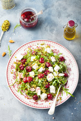 Salad with arugula, cherries and goat cheese.