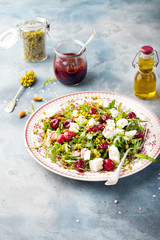 Salad with arugula, cherries and goat cheese.
