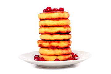 Cottage cheese pancakes with cranberries on a  plate.