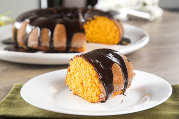Carrot cake with chocolate and slice on the table