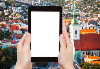 Naklejka premium tourist photographs Bratislava old town on tablet
