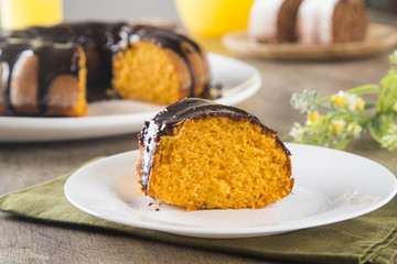 Carrot cake with chocolate and slice on the table