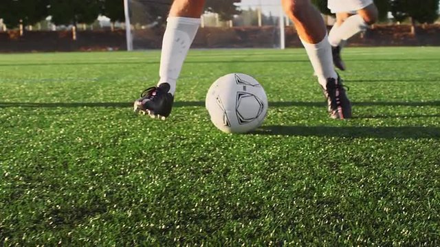 A soccer player does some fancy footwork while going up against other players
