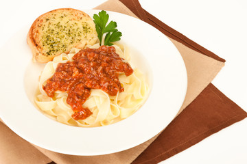 Pasta bolognese with garlic bread