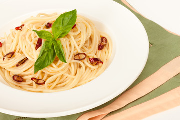 Spaghetti with red chilly pepper and fresh basil