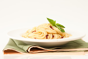 Spaghetti with red chilly pepper and fresh basil