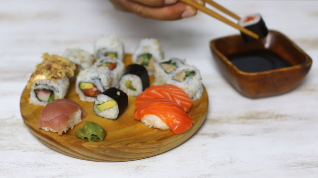 Man eating sushi in a restaurant .  Close up