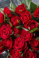 Bouquet of red roses in wicker basket
