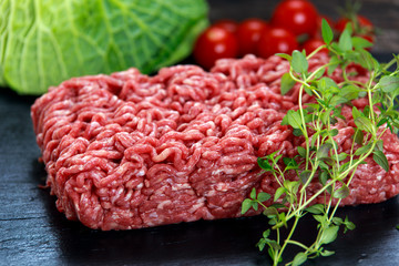 Fresh raw minced beef on old blue stone