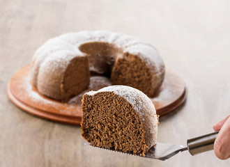 Chocolate cake on the table with carrot cake in the background.