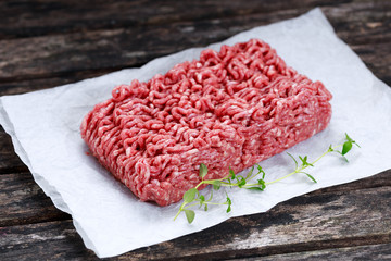 fresh raw minced beef on crumpled paper