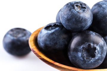 Fresh blueberries in wooden spoon