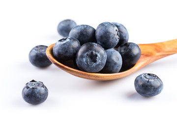 Fresh blueberries in wooden spoon