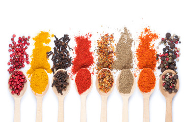 collection of spices on spoons, isolated background - obrazy, fototapety, plakaty