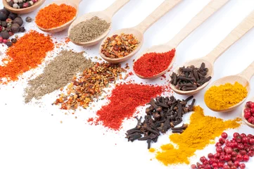 Fototapeten collection of spices on spoons, isolated background © droonny
