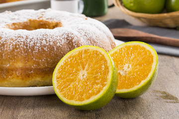 Fototapeta na wymiar Orange cake on the table with fruits and juice.