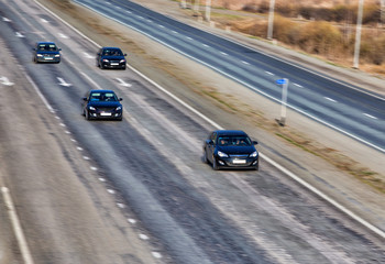 Fototapeta na wymiar cars go on highway in country