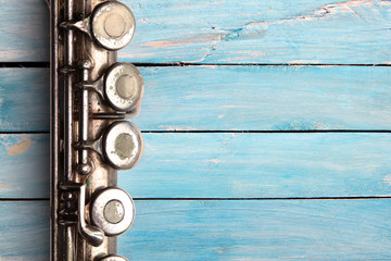 Old flute on blue wooden boards