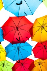 Many colorful umbrellas against the sky in city settings. Kosice, Slovakia. Color background