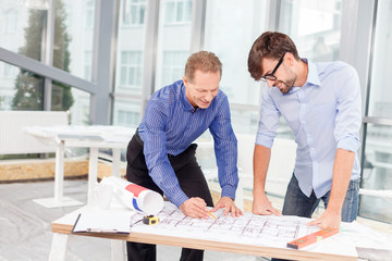 Professional male engineers are discussing new project