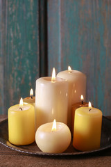 Fototapeta na wymiar Golden candles on wooden table