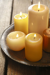 Fototapeta na wymiar Golden candles on wooden table