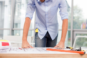Cheerful male architect is working at the office