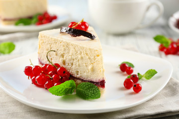 Delicious cheesecake with berries on table close up